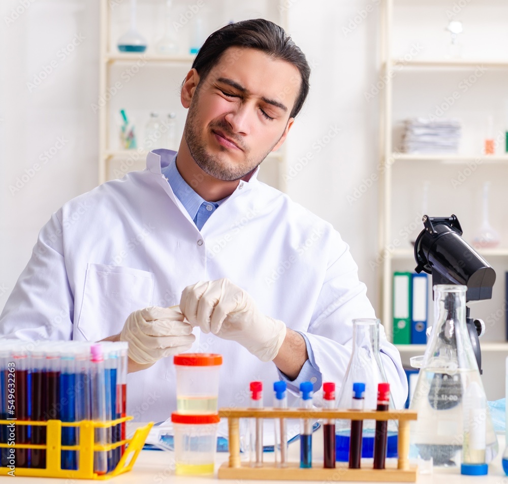 Young male chemist working in the lab Young male chemist working in the lab