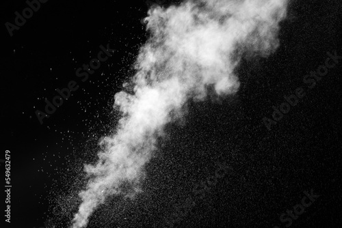 A jet of hot steam with splashes. The movement of hot steam with water droplets is highlighted on a black background to overlay your photos. Steam background, abstract smoke on a black background.