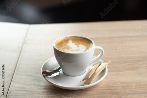 Cup of coffee in cafe on light background