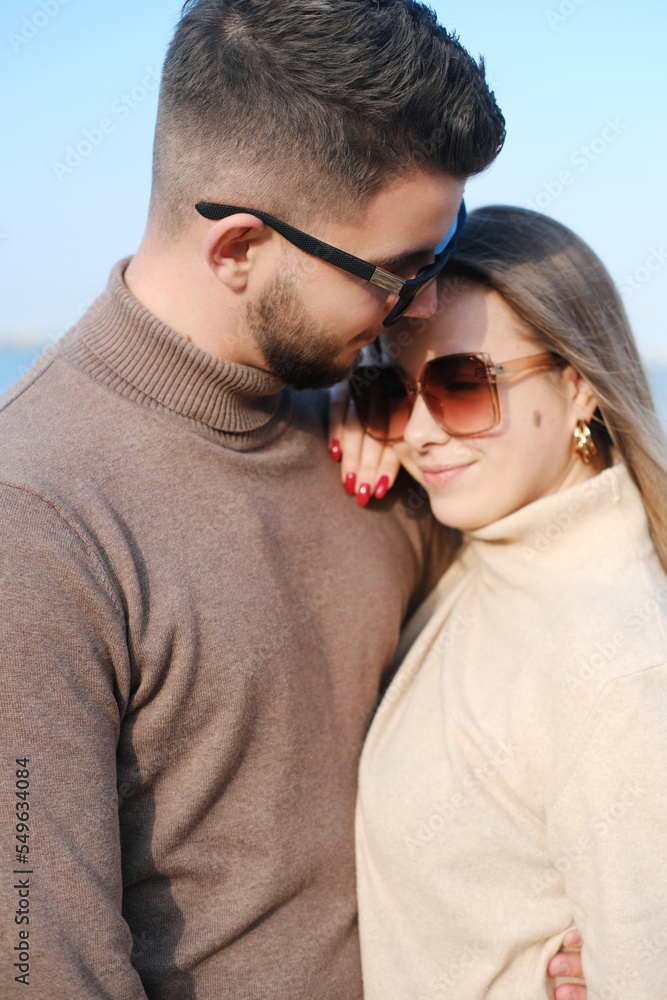 The guy hugs the girl and kisses. Close-up portrait The guy hugs the girl and kisses. Close-up portrait
