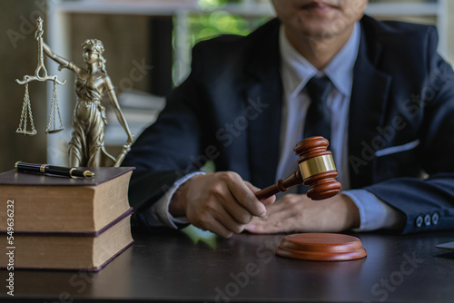 Asian lawyer working on financial information, checking financial accounts and helping clients working on desktop with legal case documents at workplace for consultant. Law, advice and justice