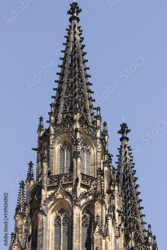 Gothic black tower of St. Vitus cathedral against blue sky in Prague Castle complex, Czech Republic. Great architecture.