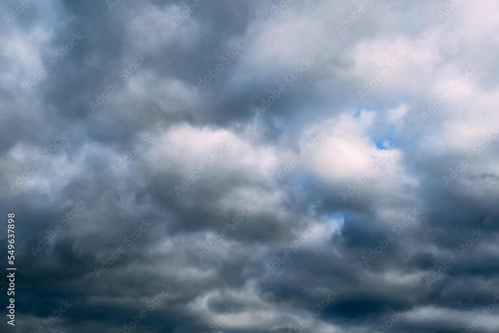 Fototapeta premium A dark blue cloudy sky. Cumulus clouds. Nature background. Bad weather forecast. Before a thunderstorm, hurricane or storm. The power and strength of nature. Air element. Wallpaper. Moving ciclone