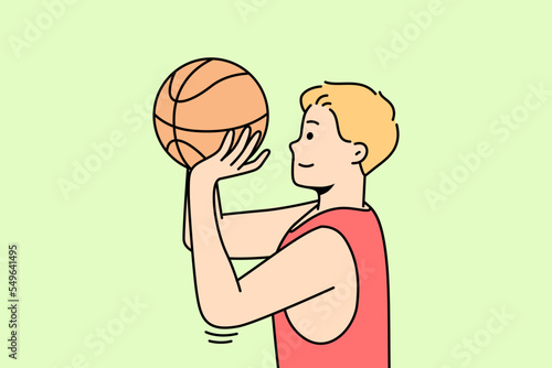 Boy throws ball into hoop or through net. Guy playing basketball or volleyball on court. Basketballer, hoopster, player trying to hit into rim. Sportsman practices drills. Young man training.