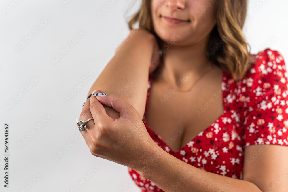 Young beautiful woman grimacing with elbow pain isolated on white background.