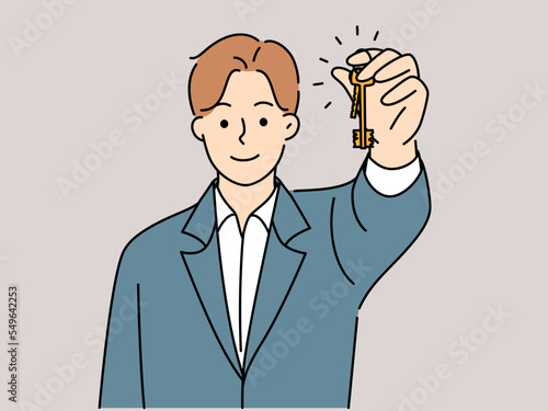 Smiling male realtor hold keys 