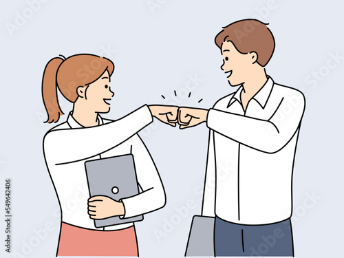 Smiling businesspeople give fists bump