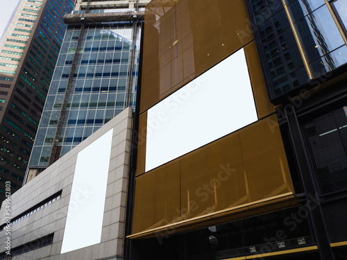 Outdoor billboard advertisement in the central business district area. Digital marketing ads on skyscrapers and commercial buildings in the financial district.