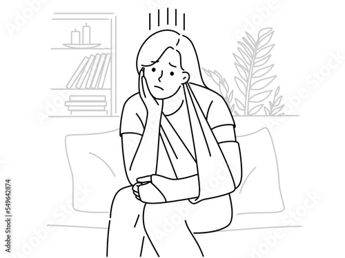 Upset woman with broken arm sit at home 