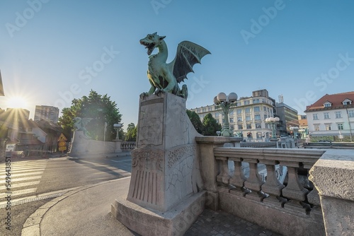 Famous dragon bridge or zmajski most, a landmark in ljublana, slovenia in early morning hours. Nobody around. Detail of dragon and piedestal. photo