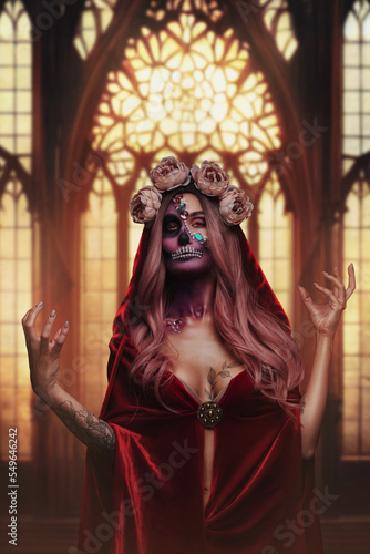 Shot of fearful demon woman with makeup dressed in red cloak and wreath of roses.
