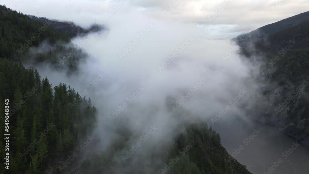 Flying towards clouds with a view over a lake, mountain and a forest Flying towards clouds with a view over a lake, mountain and a forest
