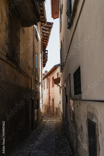 Historic ancient Italian architecture. Traditional European old town street buildings. Wooden windows  shutters and colourful pastel walls. Aesthetic summer vacation travel background