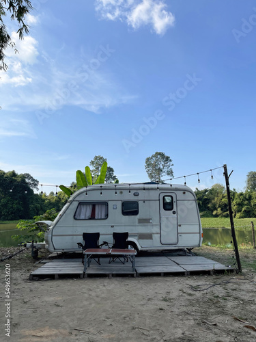 Camping with Camper Van, holiday trip in motorhome, caravan car vacation under clear blue sky 