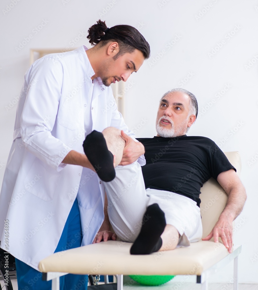 Old injured man visiting young doctor Old injured man visiting young doctor