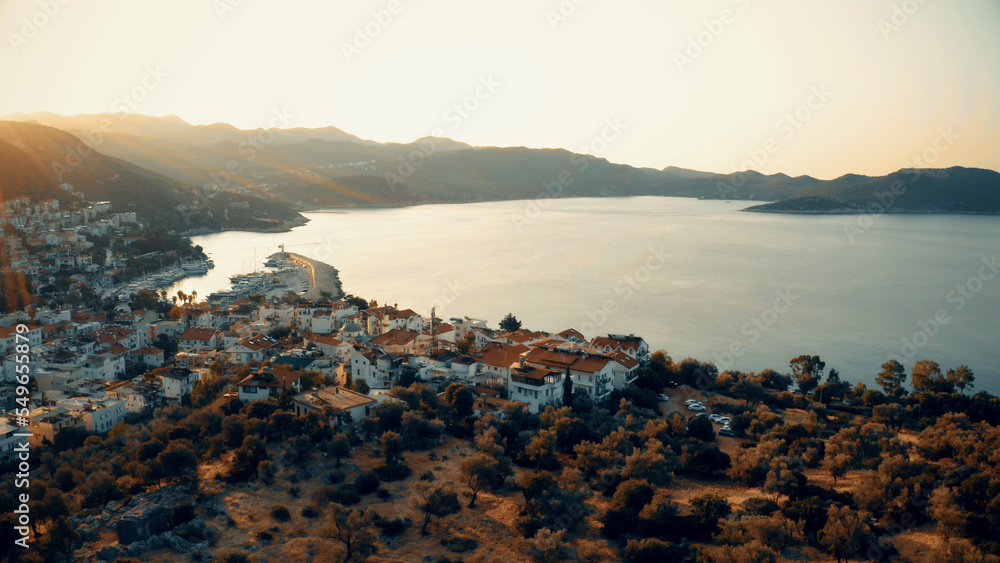 Sunset view of sea and resort town. Beautiful nature panorama from above. Travel and vacation concept.