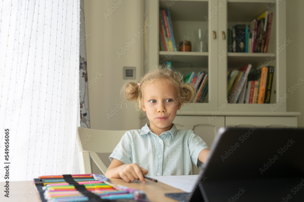 Surprised blond girl using laptop at desk Surprised blond girl using laptop at desk