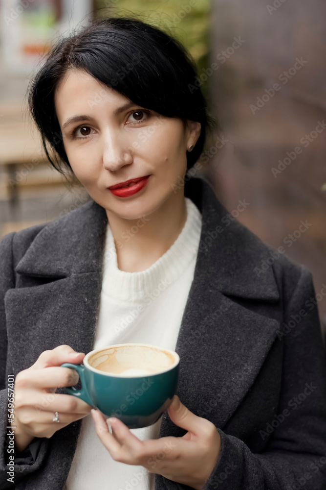 Woman with red lipstick holding coffee cup Woman with red lipstick holding coffee cup
