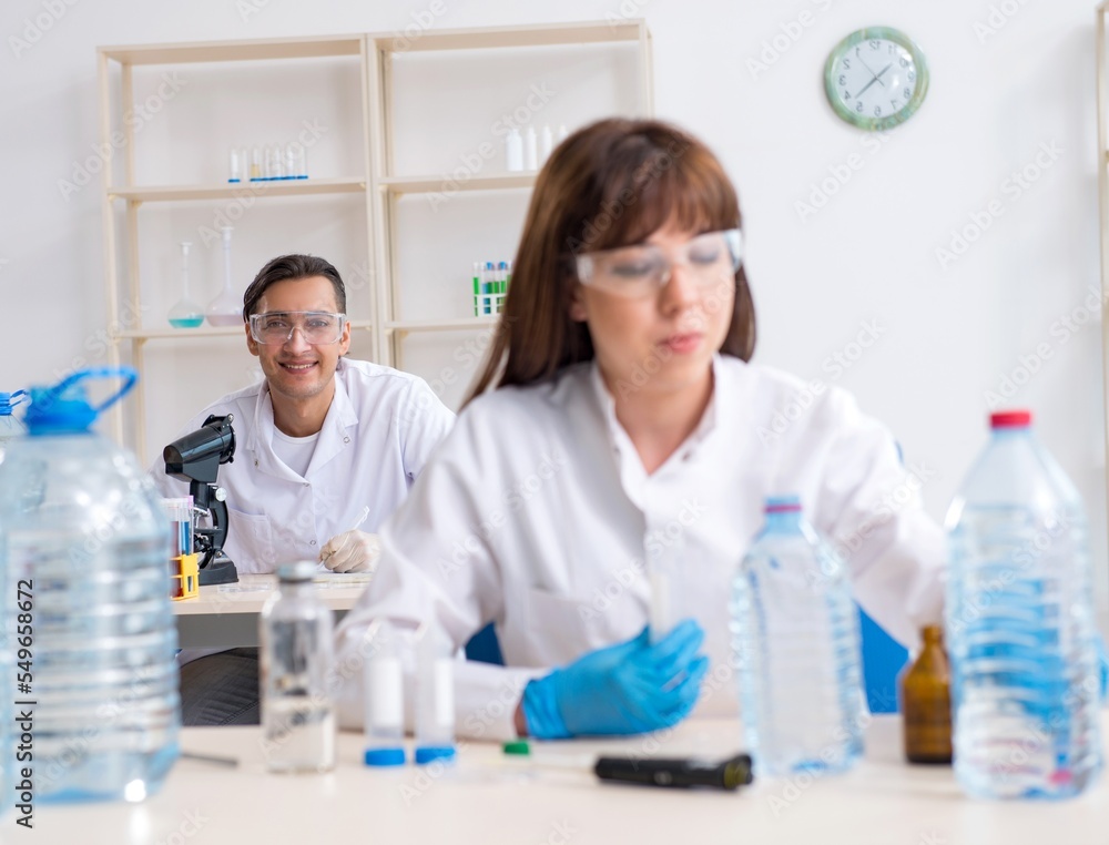 Two chemists working in the lab Two chemists working in the lab