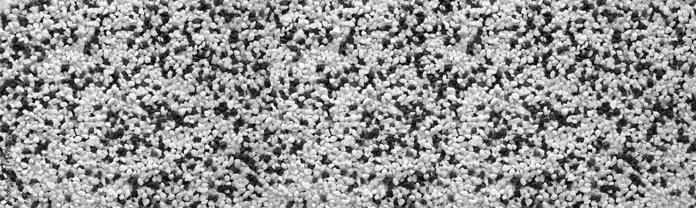 Black and white crushed stone wide texture. Panoramic textured background Black and white crushed stone wide texture. Panoramic textured background