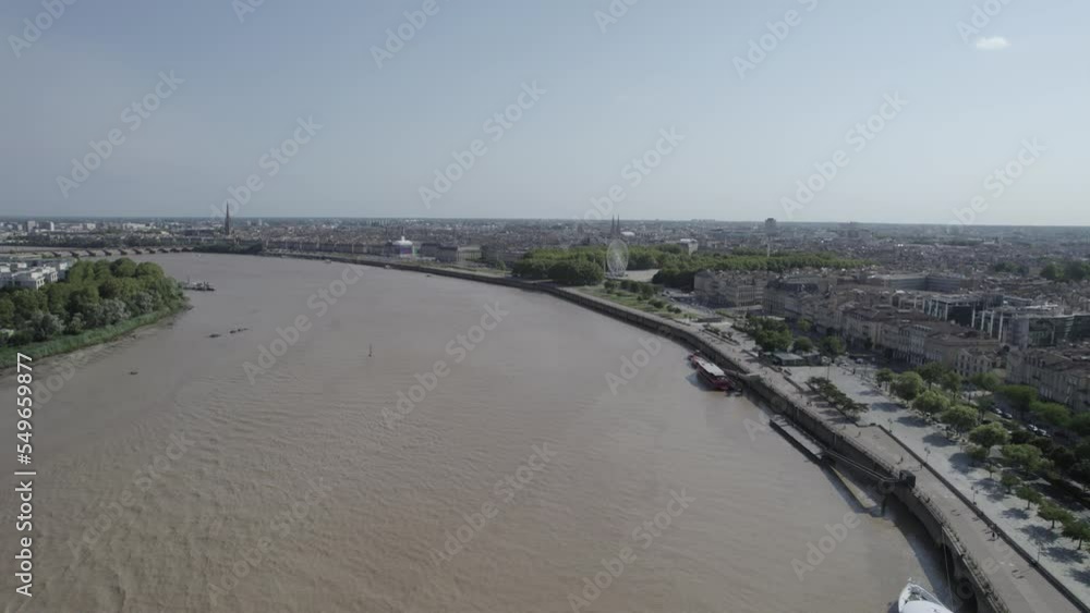 Garonne river wharfs at Chartrons neighborhood of Bordeaux France with river cruise right, Aerial dolly out shot Garonne river wharfs at Chartrons neighborhood of Bordeaux France with river cruise right, Aerial dolly out shot