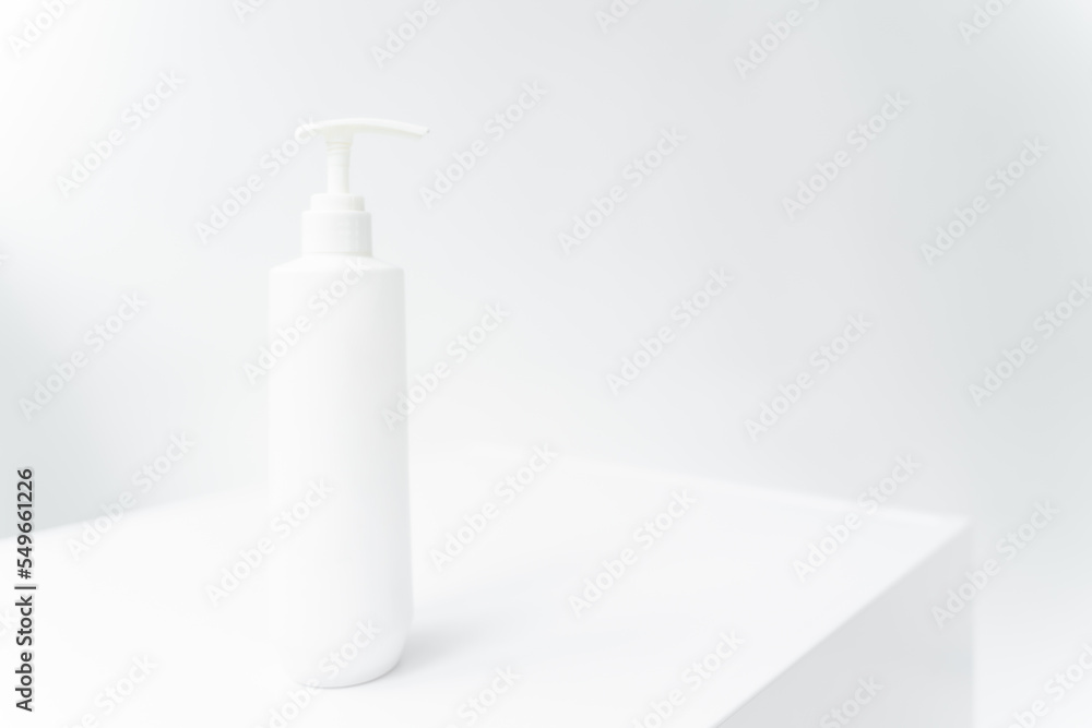 a white bottle with a dispenser on a white isolated background. Cometology, medicine a white bottle with a dispenser on a white isolated background. Cometology, medicine