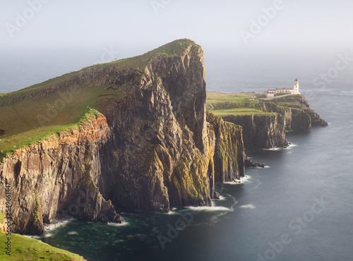 Isle of Skye lighthouse at Neist Point with beautiful golden light, beautiful landscape with sea - Scotland photo