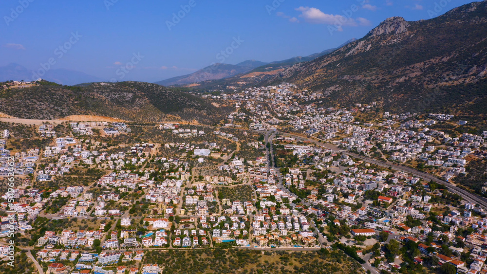 Aerial panoramic view of beautiful cityscape along mountains and sky. Touristic town in Europe.