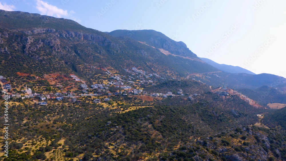 Obraz premium Landscape of cityscape in mountains. Beautiful cloudy sky in the background. Aerial panoramic view from drone.