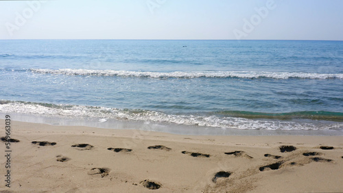 Scenic landscape of calm sea waves on sandy beach on a summer day. Beautiful seascape view.