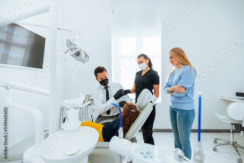 Young dentist with child patient.