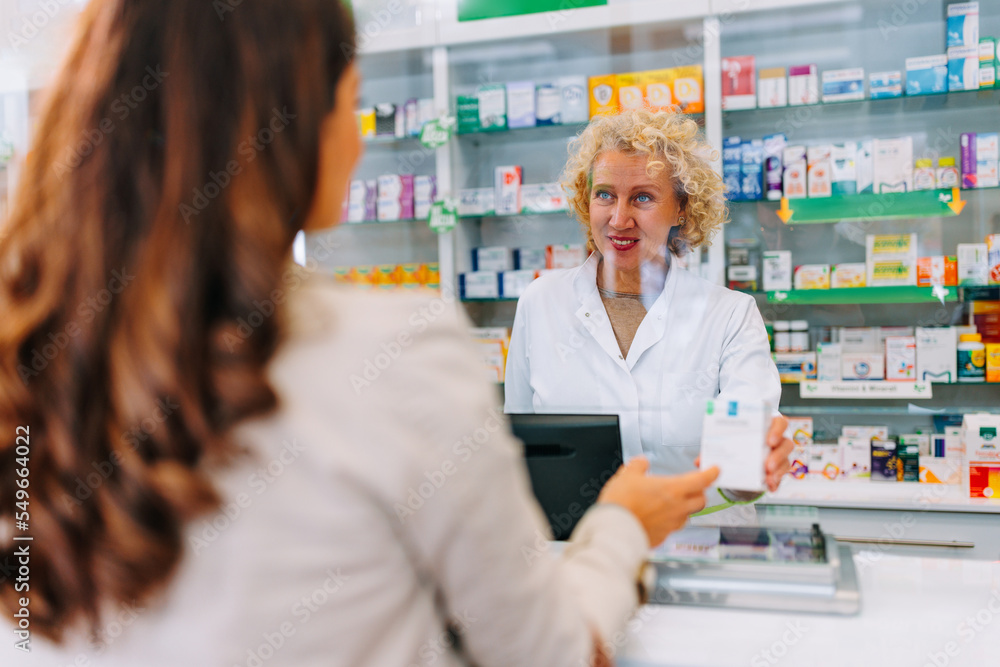 Customer buying medication at pharmacy.