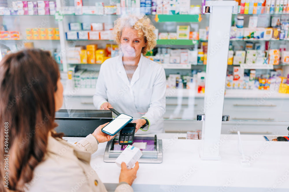 Customer paying with mobile application at pharmacy. Customer paying with mobile application at pharmacy.