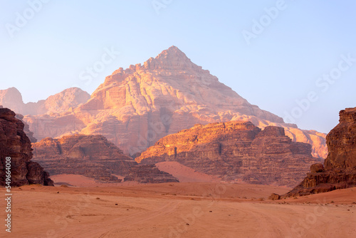 Wadi Rum, Jordan. The orange sand desert landscape and Jabal Al Qattar mountains at dawn, sunset