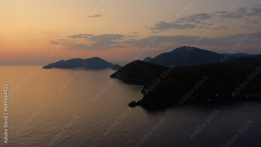 Aerial panoramic view of tropical bay at sunset. Seascape with mountains and rocky islands. Nature scenery.