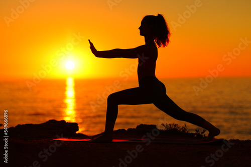 Female doing tai chi at sunset