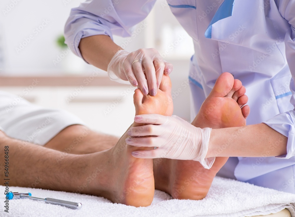 Podiatrist treating feet during procedure