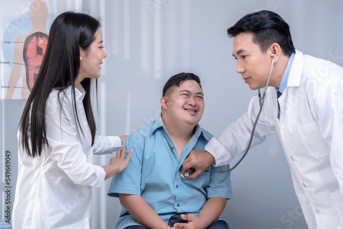 Asian mother and son visit the doctor to discuss health problems.
