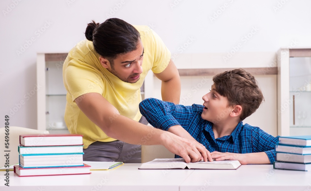 Father helping his son to prepare for school Father helping his son to prepare for school