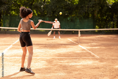 Two young people playing tennis and looking excited © zinkevych