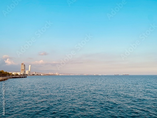 picturesque sea scape panorama background with promenade and distant buildings glass skyscrapers, Limassol, Cyprus