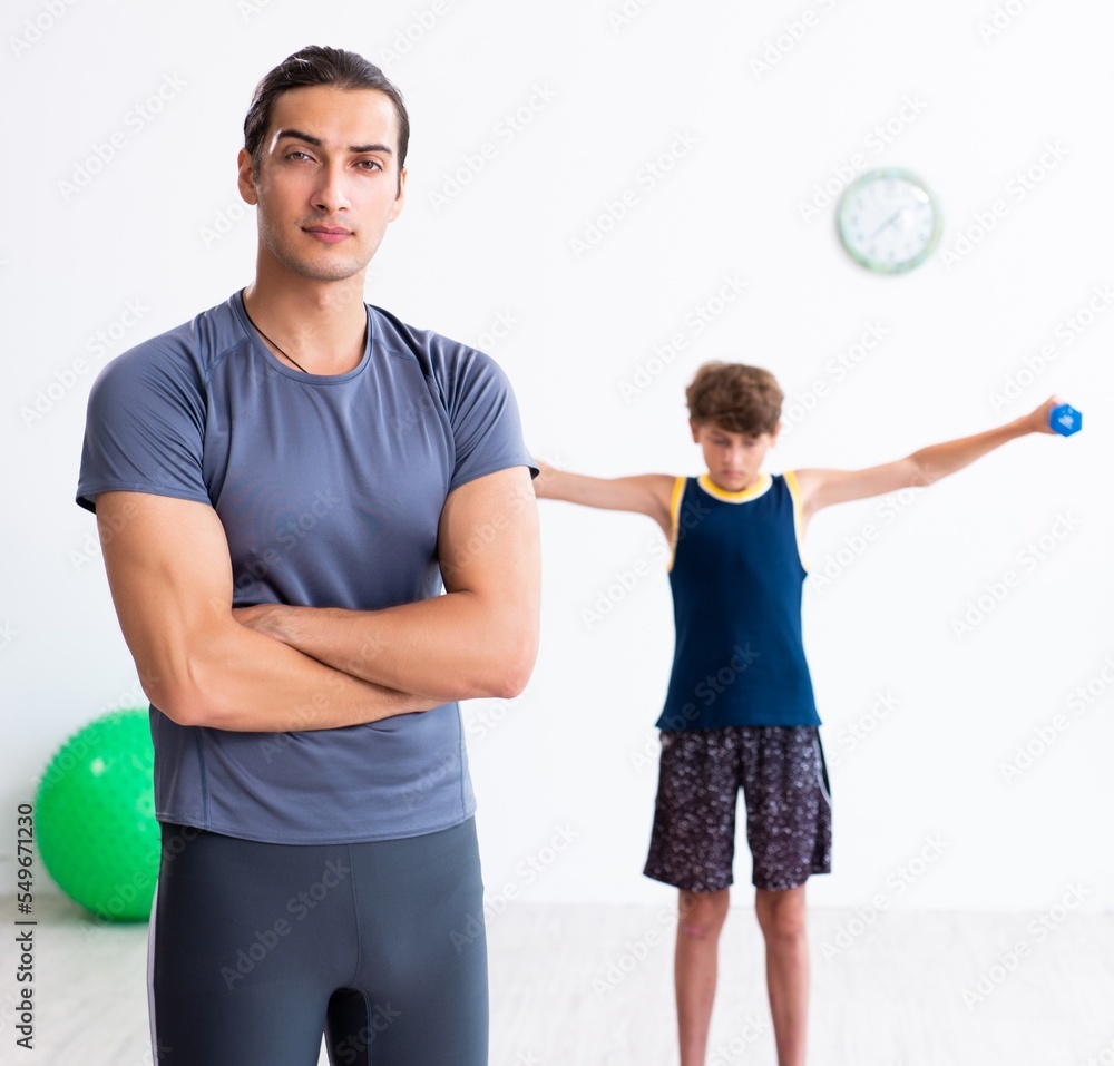 Young father and his son doing exercises Young father and his son doing exercises
