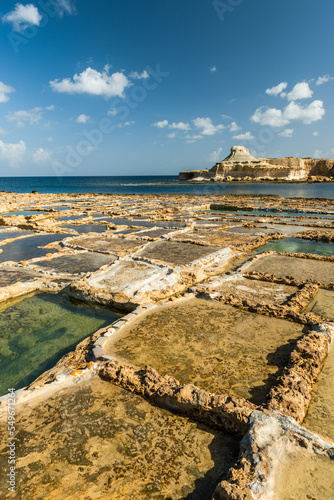 Traditional salt pans in Xwejni Bay on the beach of island of Gozo, Malta. photo