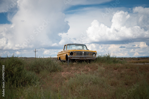 Old yellow Ford Rancherto pickup truck abandoned in the desert