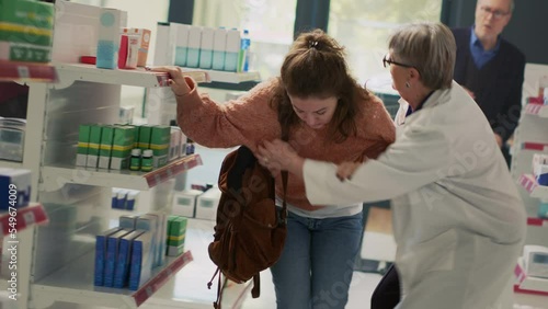 Female client with spinning sensation and dizziness losing balance in pharmacy shop, almost fainting at drugstore. Woman feeling off and dizzy, losing consciousness and falling down. Dutch angle.