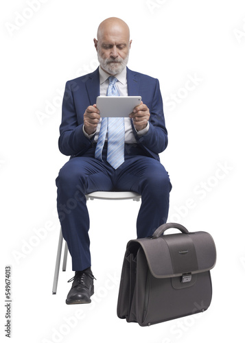 PNG file no background Businessman sitting and using a tablet photo