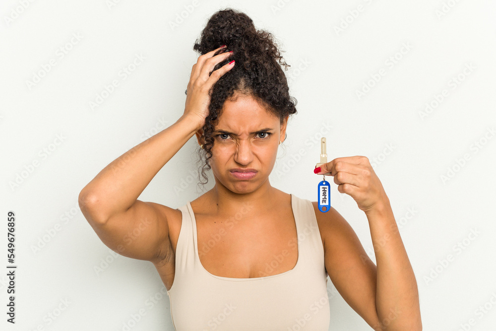 Young brazilian woman holding home keys isolated being shocked, she has remembered important meeting. Young brazilian woman holding home keys isolated being shocked, she has remembered important meeting.