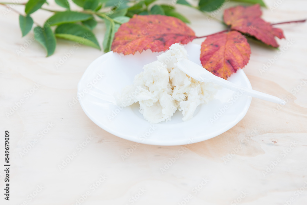 Shea butter on light background, unrefined, close up Shea butter on light background, unrefined, close up
