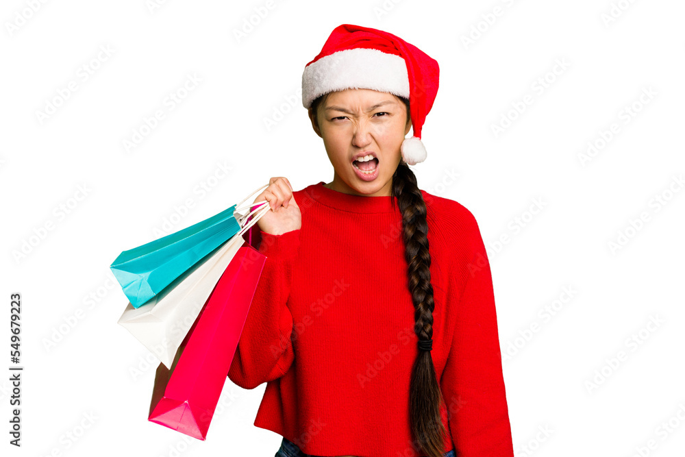 Young asian woman shopping a christmas presents isolated Young asian woman shopping a christmas presents isolated screaming very angry and aggressive.