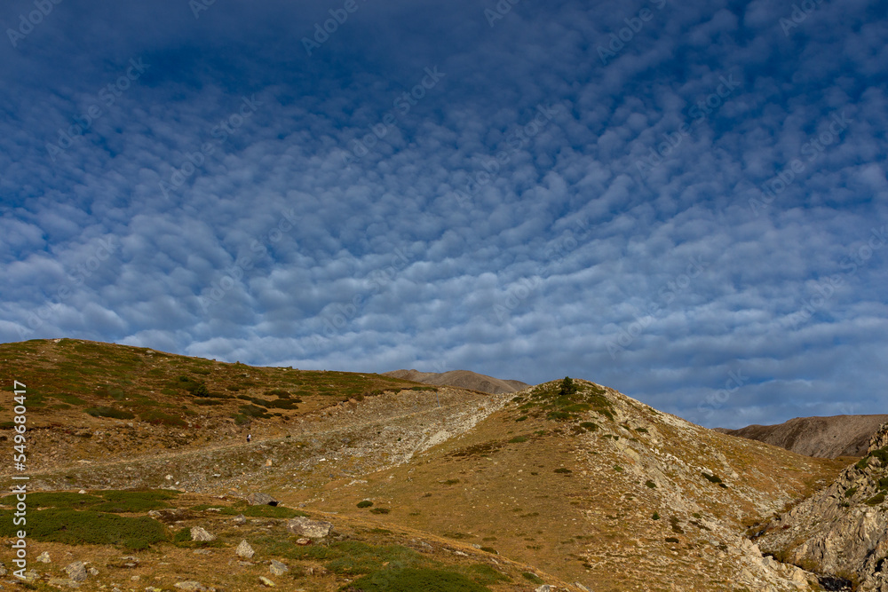 High mountains with Cirrocumulus clouds in the sky High mountains with Cirrocumulus clouds in the sky